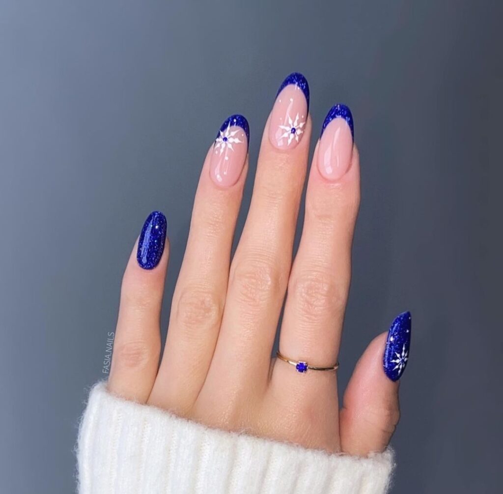 blue glittery nail tips with white nail designs