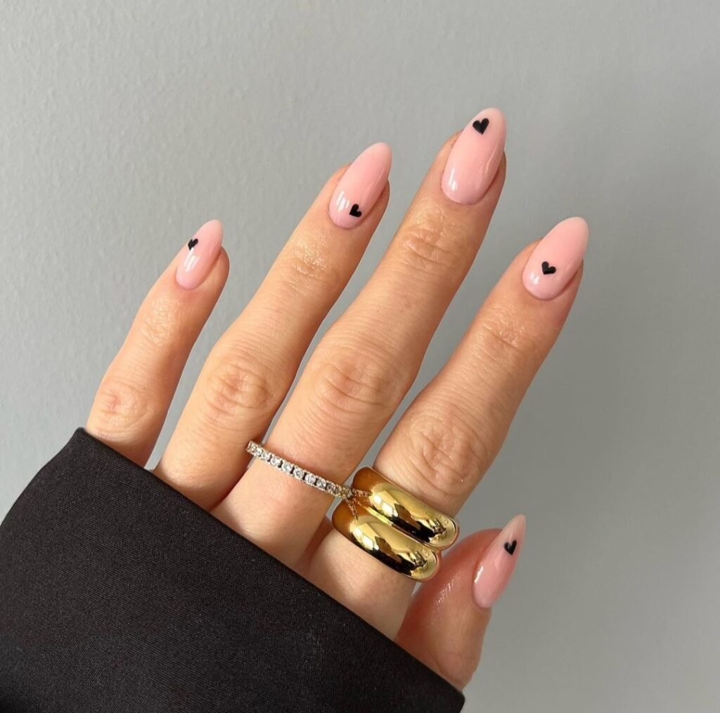 nude nails with mini black hearts