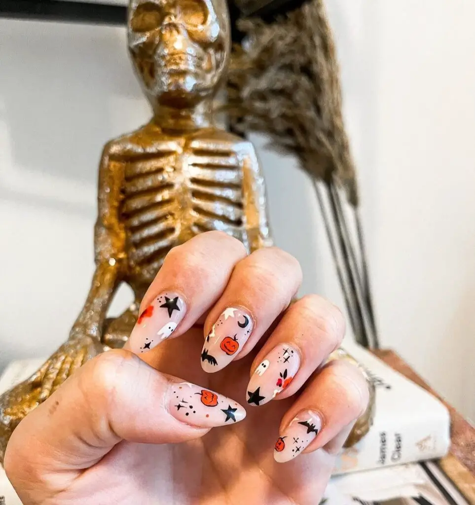 cute Halloween nail designs with pumpkins, bats, and stars
