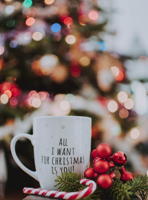 Free Selective Focus Photography of Ceramic Mug Near Candy Cane Stock Photo