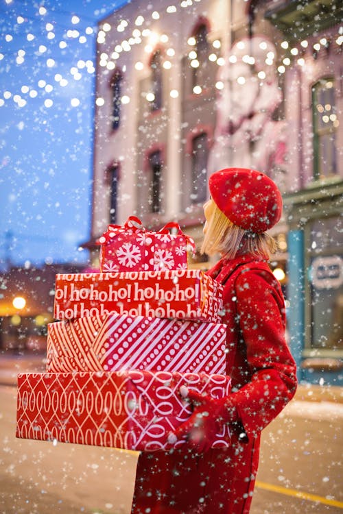 Free Woman Holding Three Red Christmas Presents Boxes Stock Photo